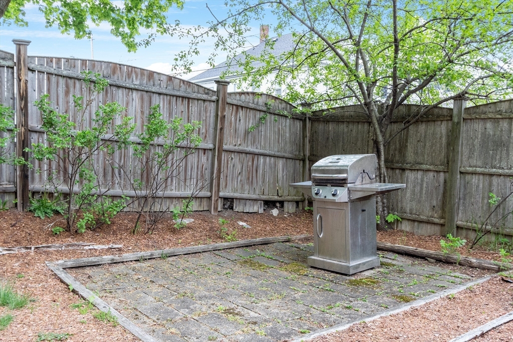 42 Farmland Road, Unit D Lowell, MA 01850 - Photo 23 of 26 a view of a backyard with wooden fence