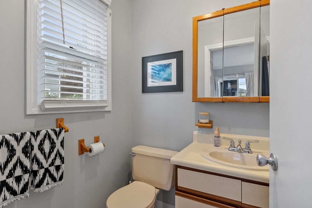 42 Farmland Road, Unit D Lowell, MA 01850 - Photo 5 of 26 a bathroom with a sink toilet and a mirror