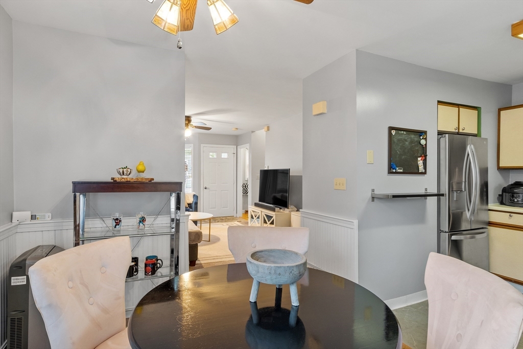 42 Farmland Road, Unit D Lowell, MA 01850 - Photo 6 of 26 a room with furniture a flat screen tv and a dining table