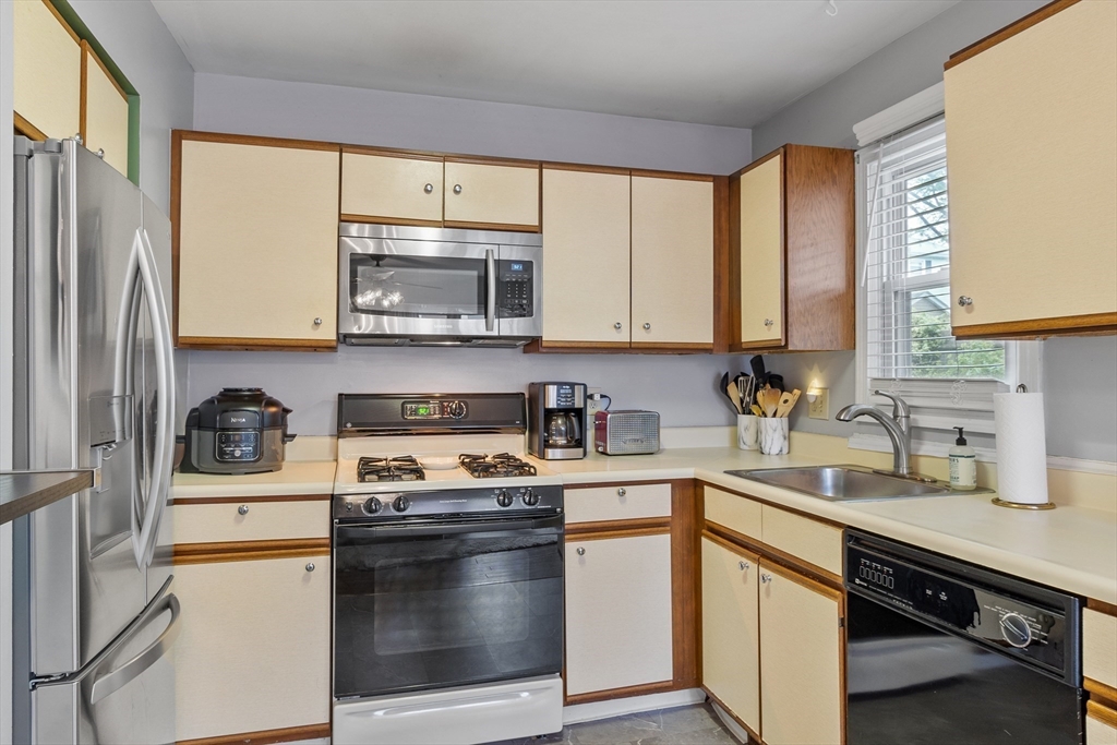 42 Farmland Road, Unit D Lowell, MA 01850 - Photo 9 of 26 a kitchen with a sink stove and microwave