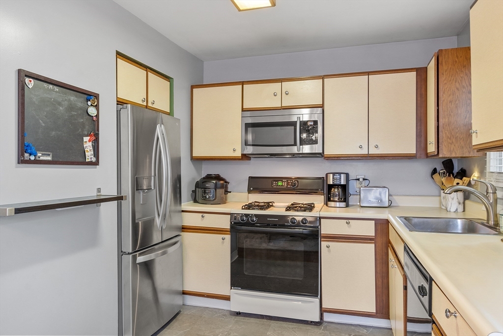 42 Farmland Road, Unit D Lowell, MA 01850 - Photo 10 of 26 a kitchen with a refrigerator stove and sink