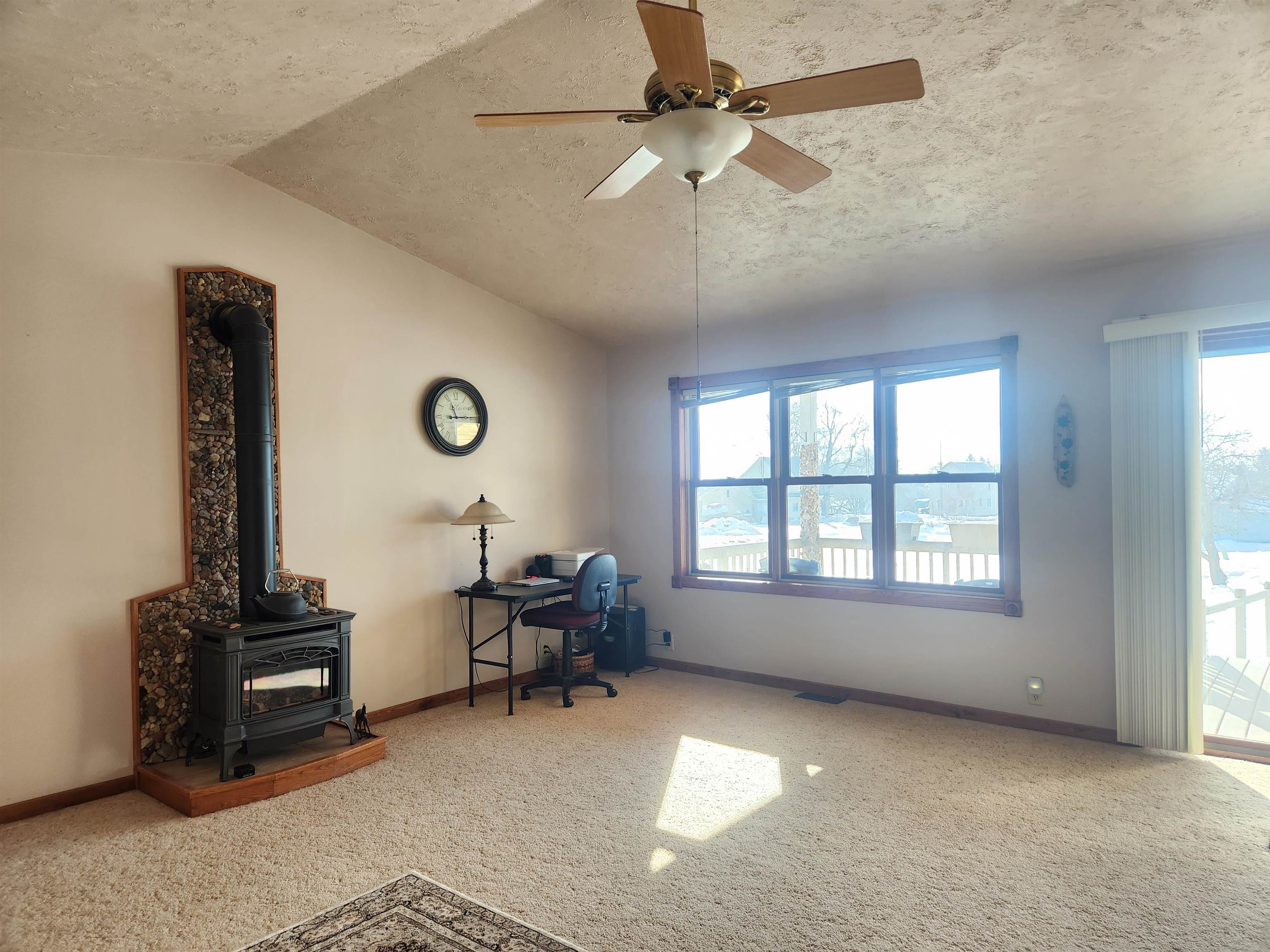 608 West 3rd Street Washburn, WI 54891 - Photo 3 of 26 Cozy living room with gas fireplace, patio doors to porch and a vaulted ceiling.