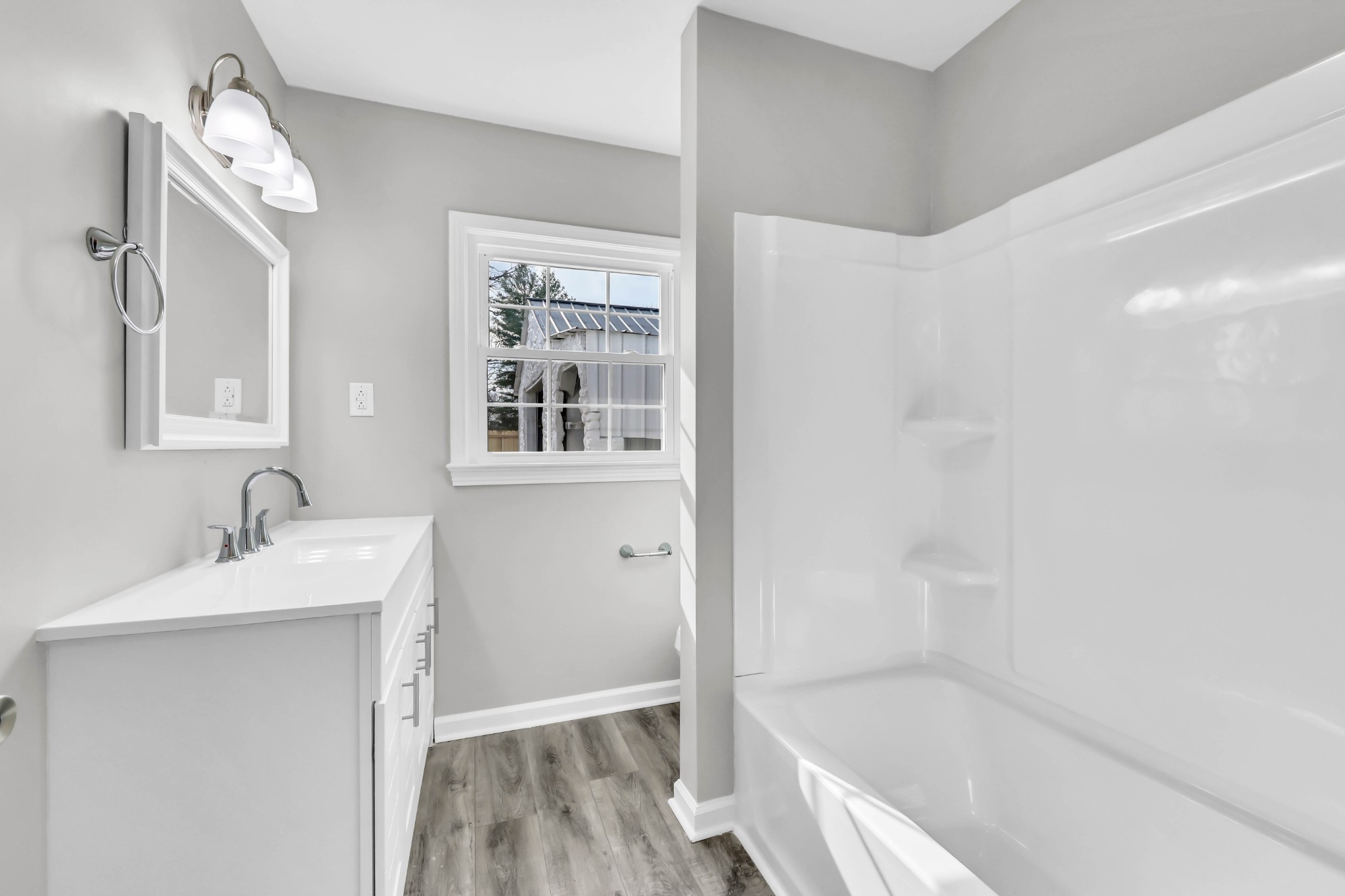 3436 State Highway 48 Cunningham, TN 37052 - Photo 25 of 45 a bathroom with a granite countertop sink a mirror and a bathtub