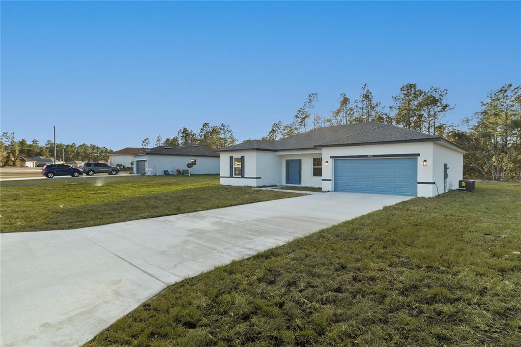 5534 Southwest 152nd Lane Road Ocala, FL 34473 - Photo 18 of 19 a view of a house with backyard and garden