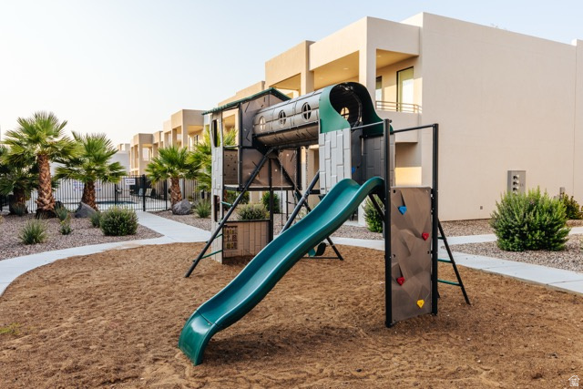 1122 South 1790th West, Unit 1 St. George, UT 84770 - Photo 35 of 37 Community playground featuring a slide and climbing wall set in a sand base