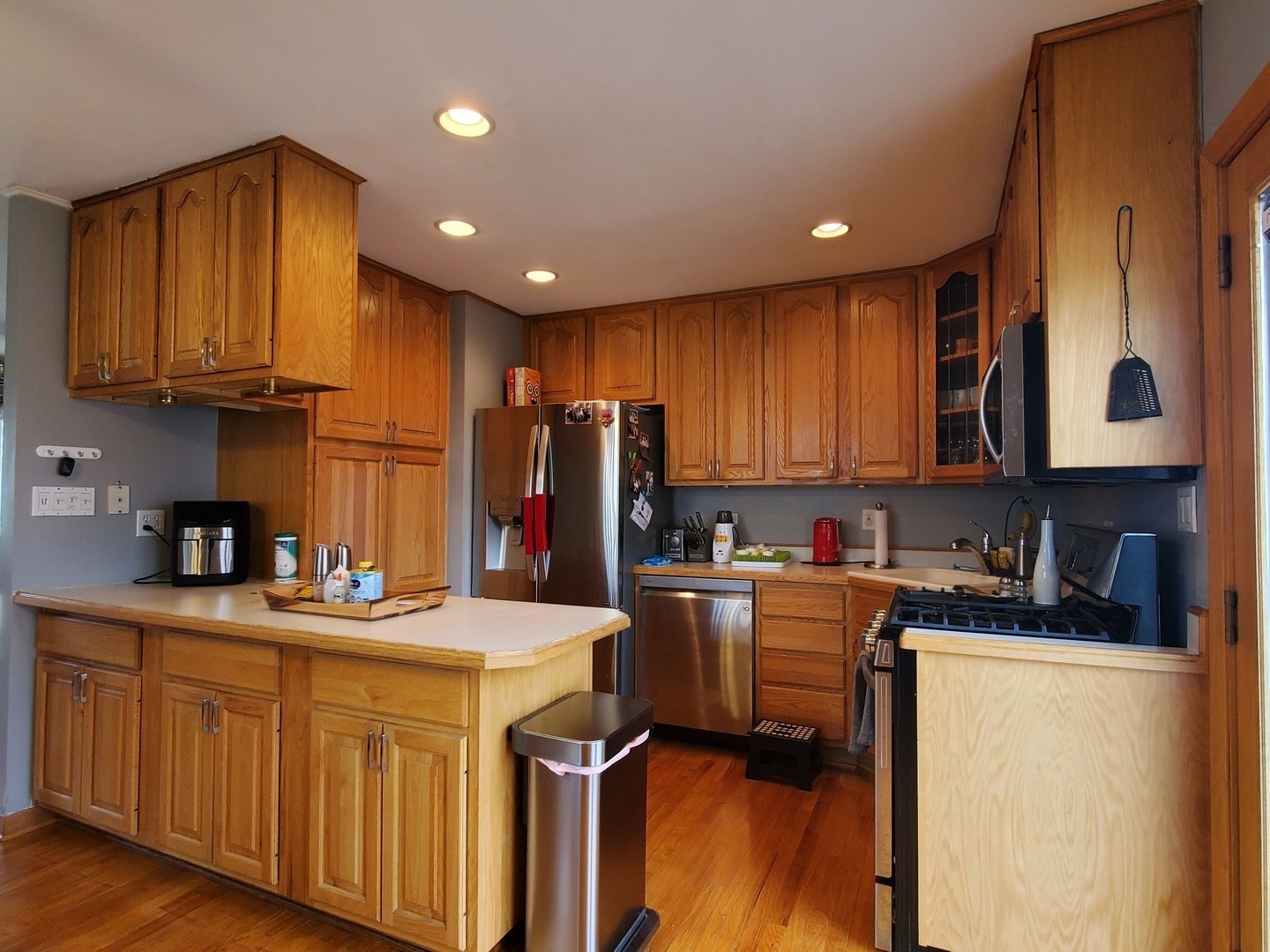 153 Fletcher Drive Wheeling, IL 60090 - Photo 4 of 22 a kitchen with stainless steel appliances granite countertop a sink refrigerator and cabinets