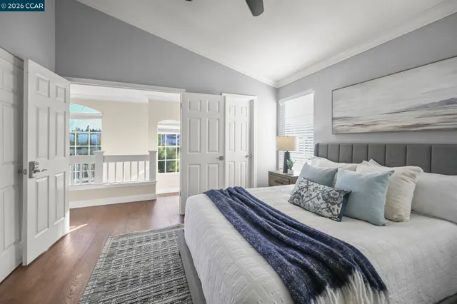 a bedroom with a large bed and a rug