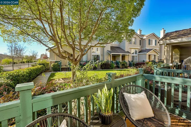 a view of a chair and tables in the balcony