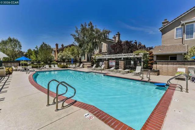 a swimming pool with outdoor seating and yard