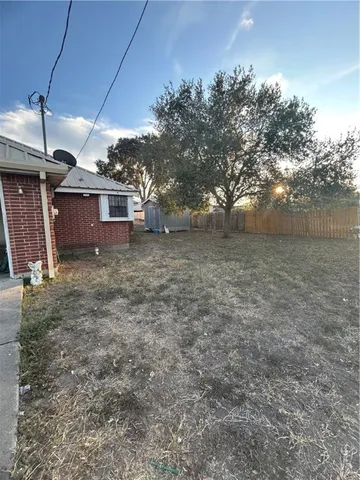 a view of a house with a backyard