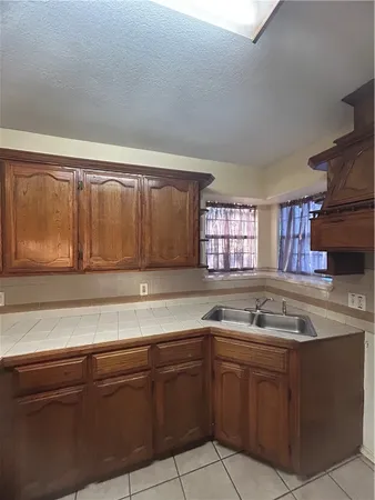 a kitchen with a sink and cabinets