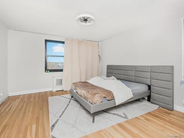 a bedroom with a bed and a night stand