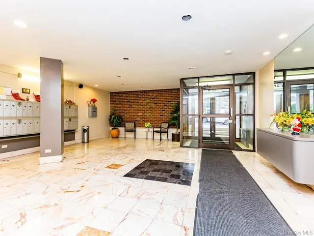 a large white room with many windows and view of living room