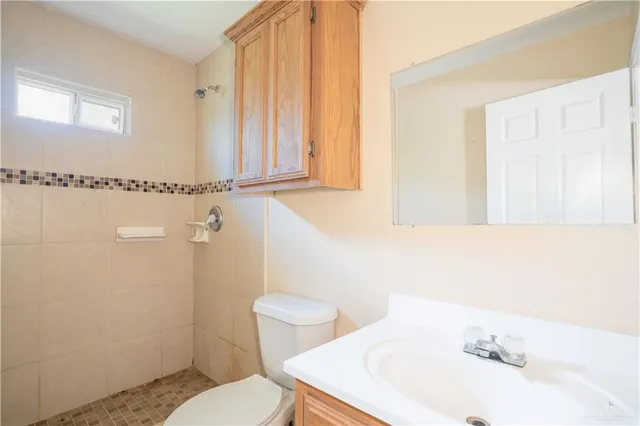 a bathroom with a sink a toilet and a mirror