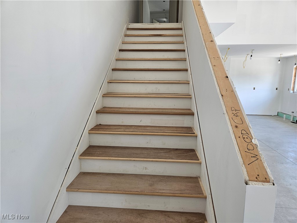1180 North County Line Road Geneva, OH 44041 - Photo 23 of 33 Stairway with concrete flooring