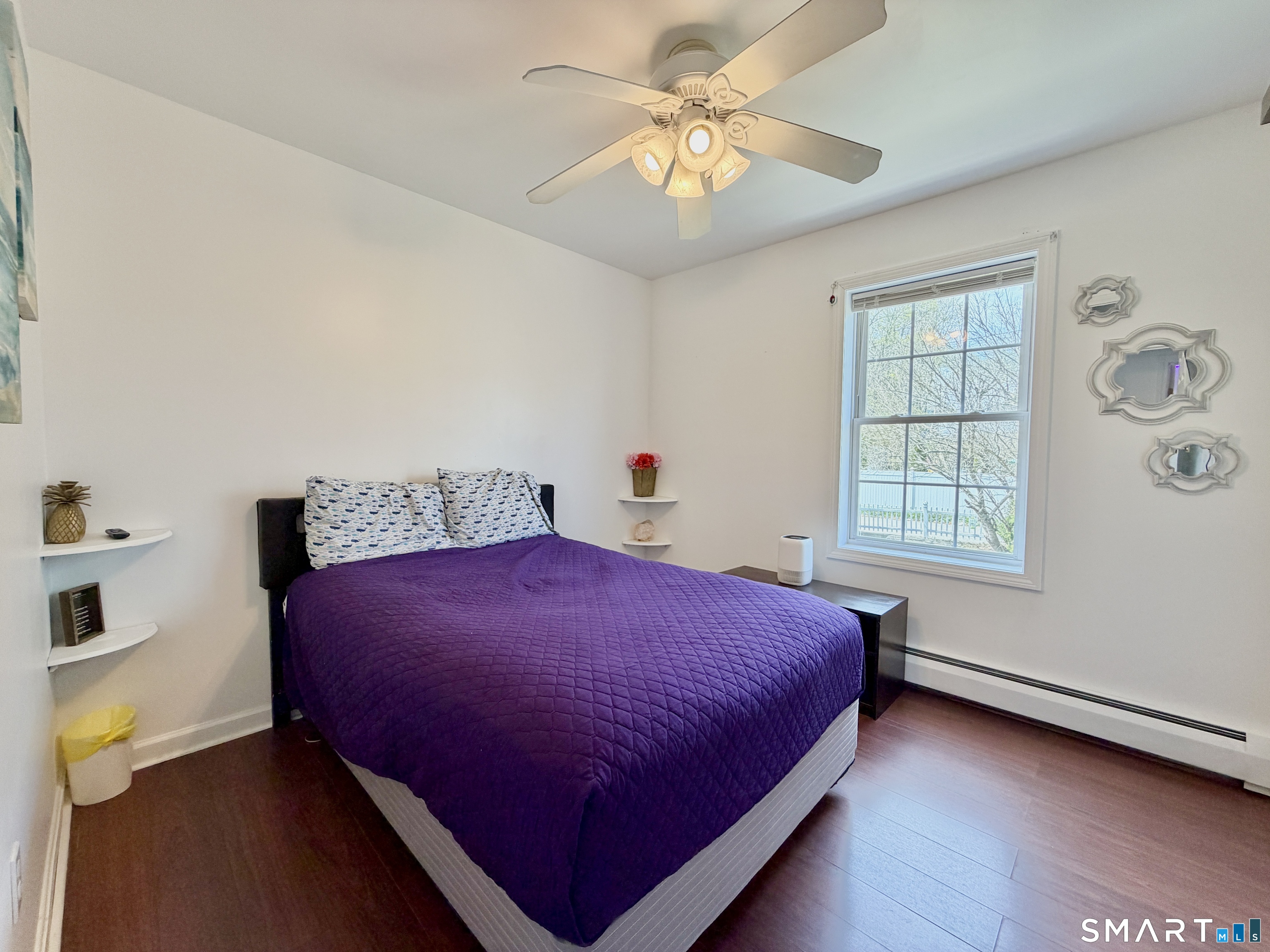 24 Quarry Street Norwich, CT 06360 - Photo 13 of 20 a bedroom with a bed and a chandelier