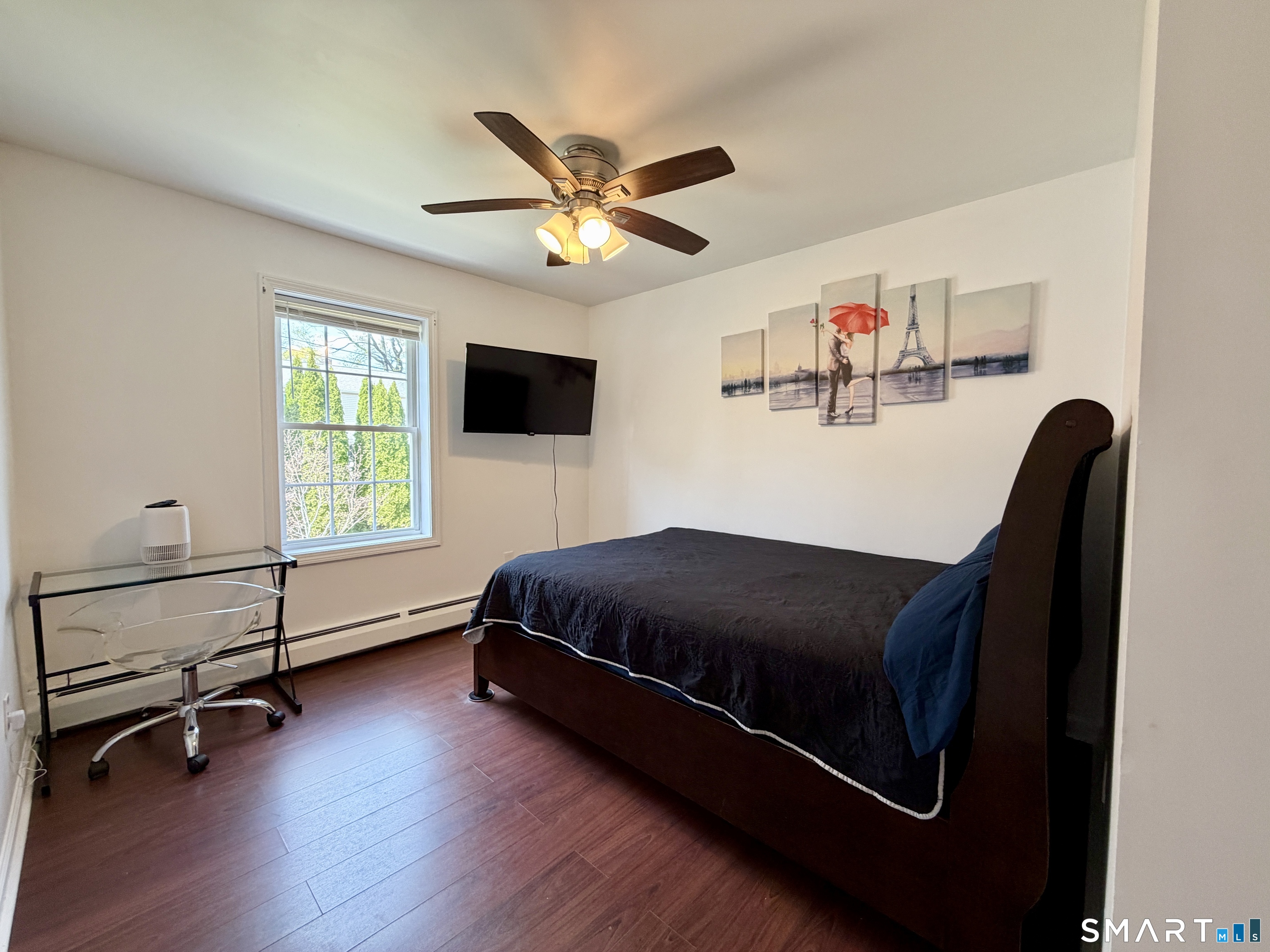 24 Quarry Street Norwich, CT 06360 - Photo 14 of 20 a bedroom with a bed and a chandelier