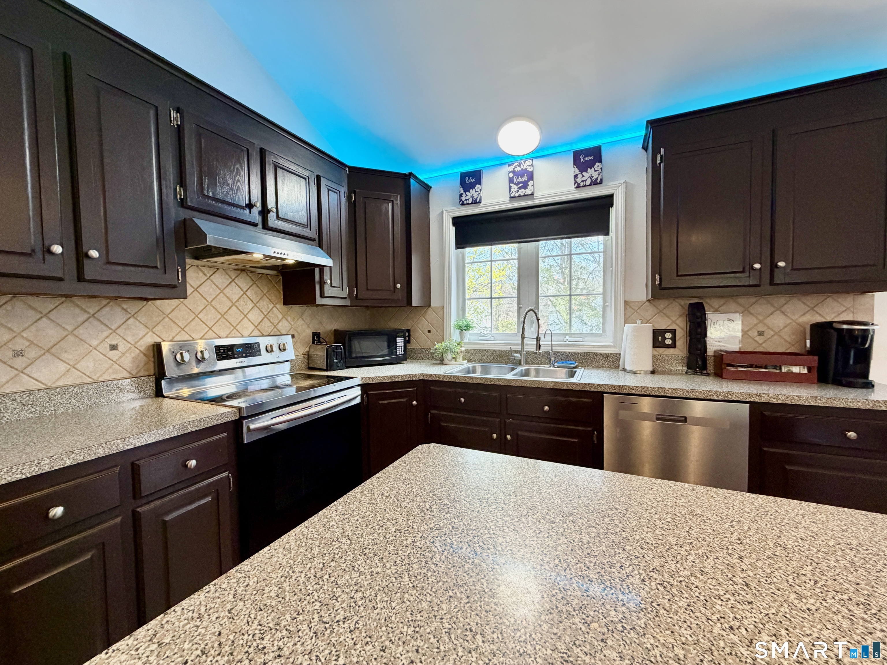 24 Quarry Street Norwich, CT 06360 - Photo 7 of 20 a kitchen with stainless steel appliances granite countertop a stove sink microwave and window
