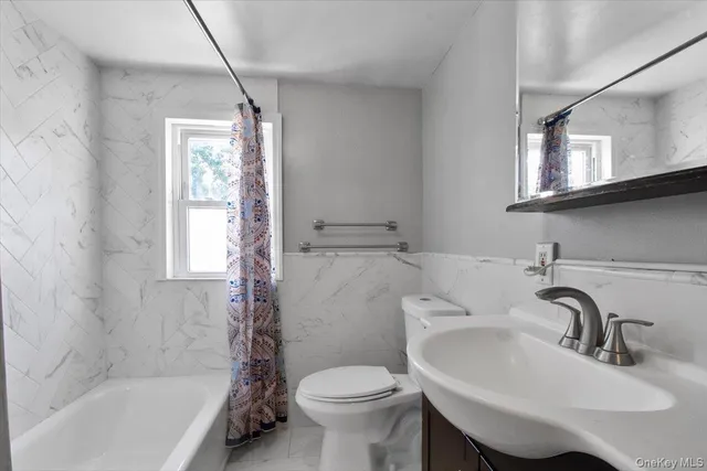 a bathroom with a sink toilet and a bathtub