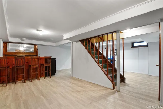 a view of a hallway with wooden floor and stairs