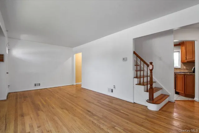 a view of a room with wooden floor and stairs