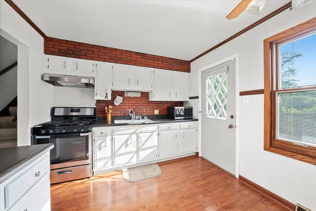 a kitchen with stainless steel appliances granite countertop a stove a sink and a refrigerator