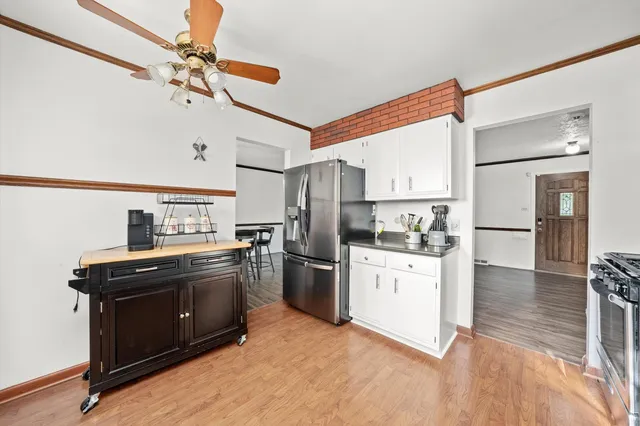 a kitchen with stainless steel appliances granite countertop a sink a stove and a refrigerator