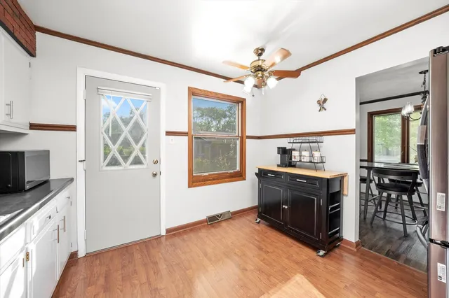a kitchen with stainless steel appliances a stove a microwave and white cabinets