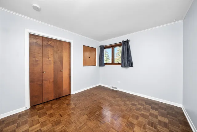 an empty room with windows and closet