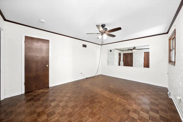 a view of a big room with wooden floor and windows