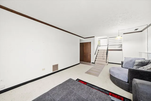 a living room with furniture and white walls