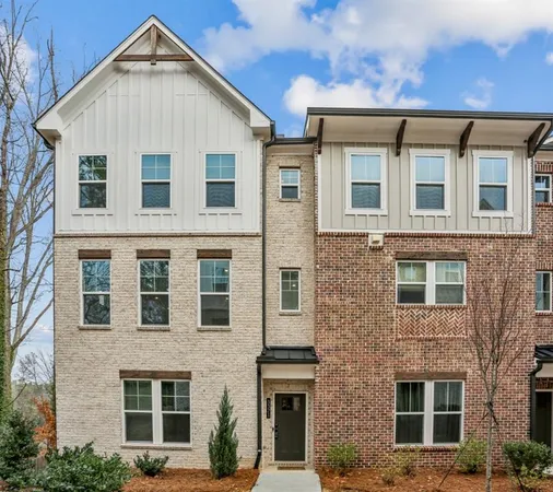 a view of a brick house with large windows