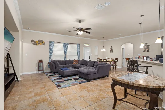 a living room with furniture a fireplace and a chandelier