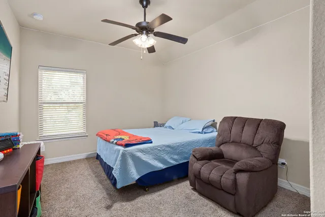 a bedroom with a bed couch and window
