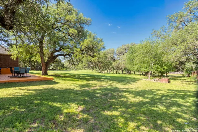 a swimming pool with outdoor seating and yard