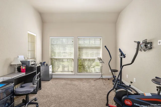 a room with gym equipment and a window
