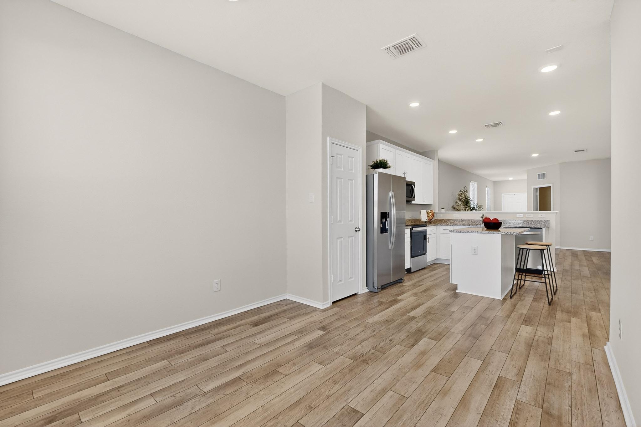 429 Stone Water Lane Jarrell, TX 76537 - Photo 37 of 37 a kitchen with a refrigerator and wooden floor