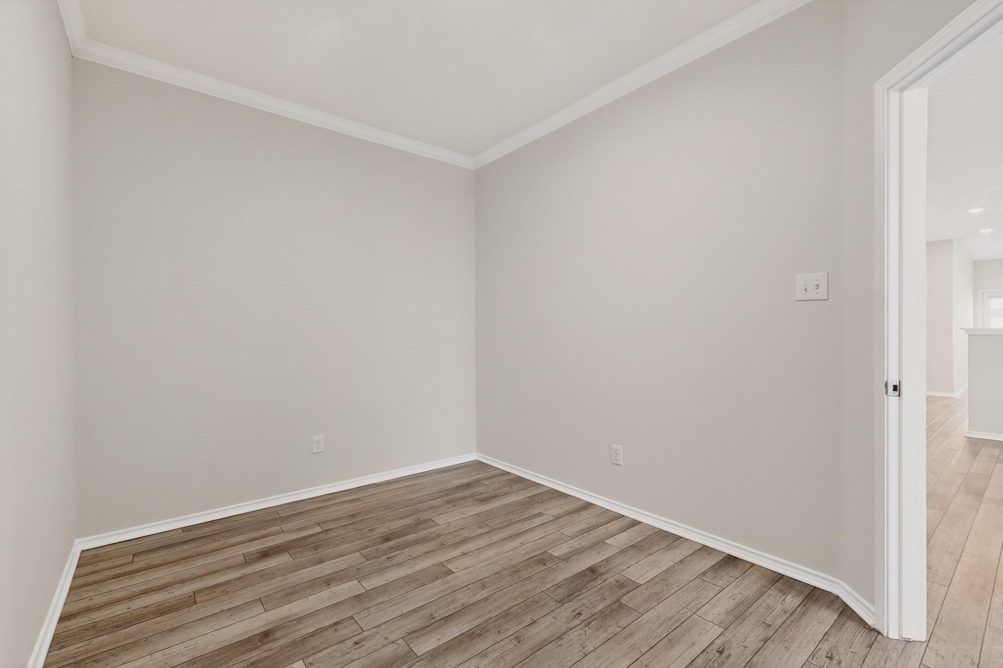 429 Stone Water Lane Jarrell, TX 76537 - Photo 14 of 37 a view of an empty room with wooden floor