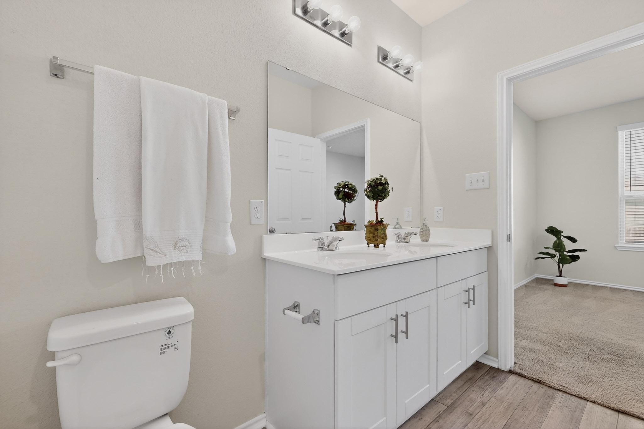 429 Stone Water Lane Jarrell, TX 76537 - Photo 19 of 37 a bathroom with a sink a toilet and shower