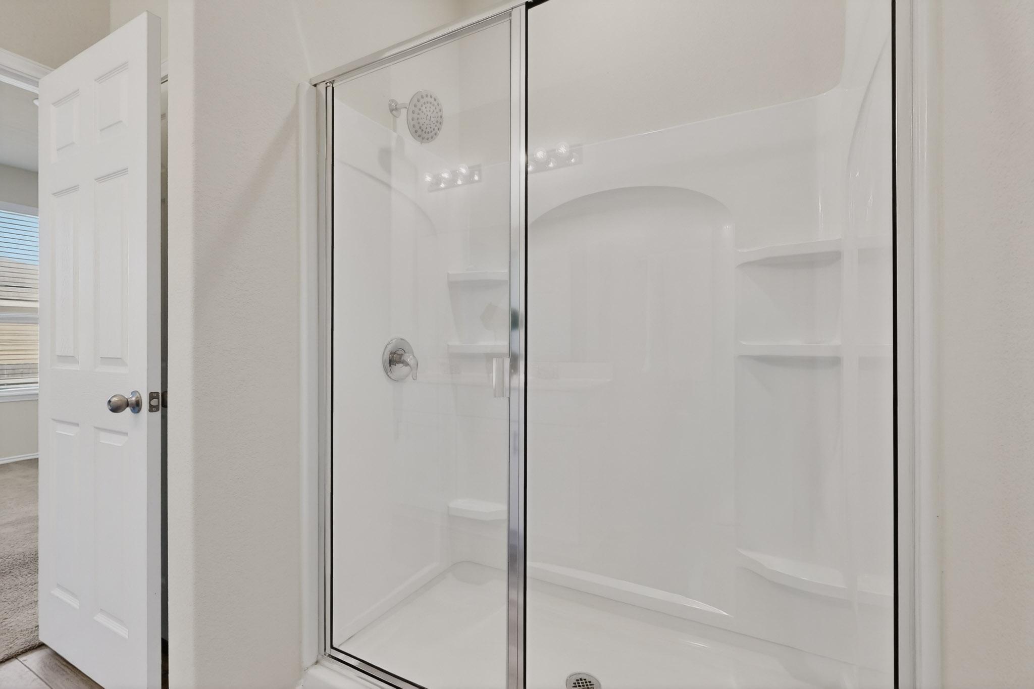 429 Stone Water Lane Jarrell, TX 76537 - Photo 20 of 37 a bathroom with a glass shower door