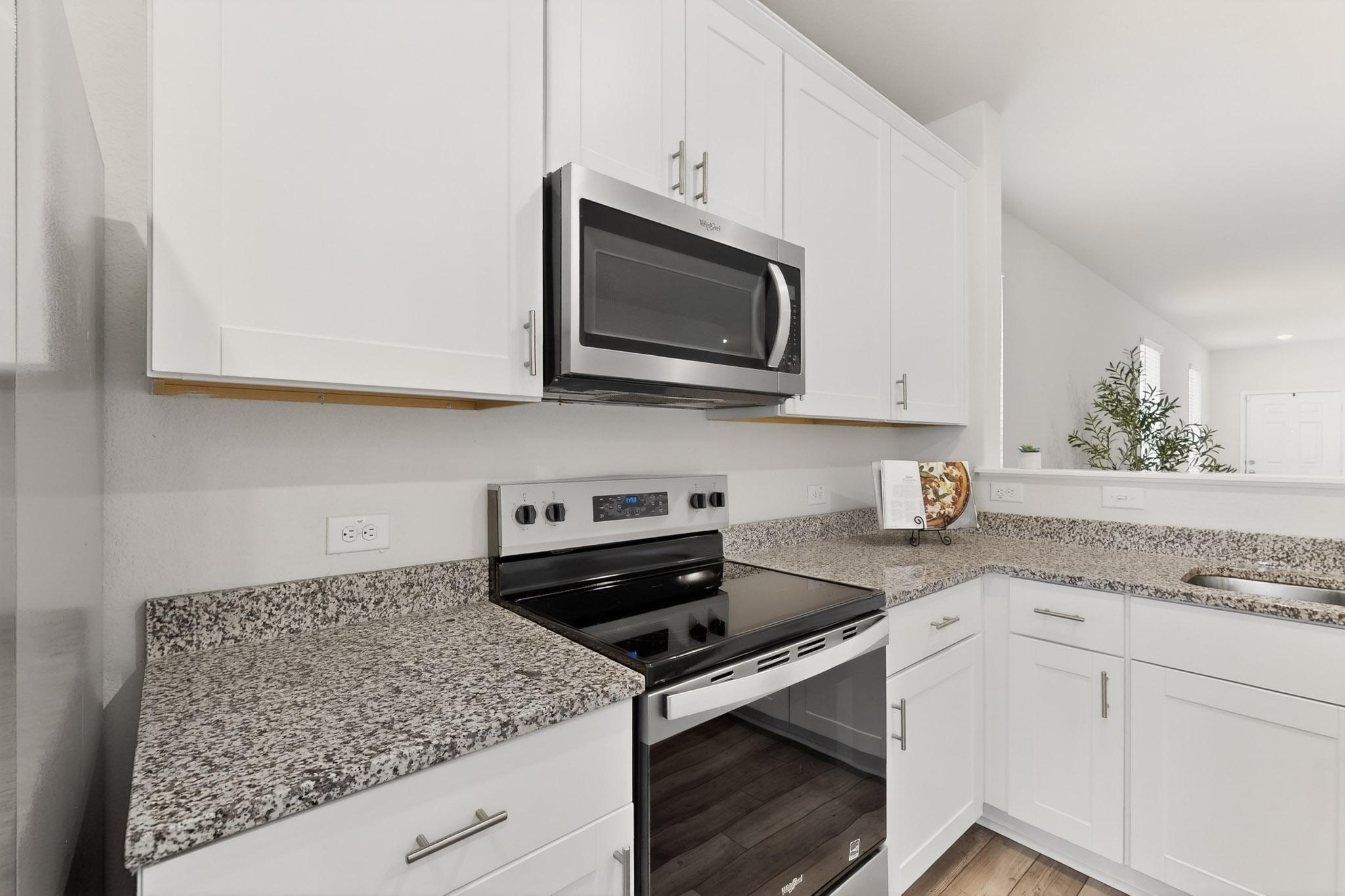 429 Stone Water Lane Jarrell, TX 76537 - Photo 9 of 37 a kitchen with appliances cabinets and a counter top space