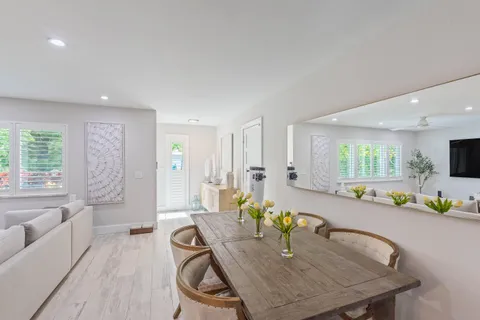a dining room with furniture and a kitchen view