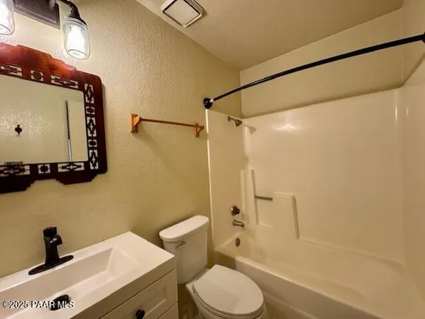 a bathroom with a sink a toilet and a shower