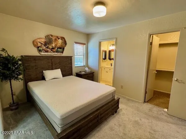 a bed sitting in a bedroom and a table