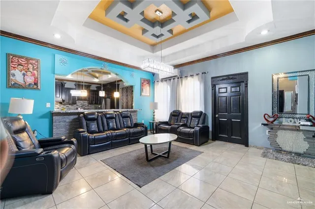 a living room with furniture and a chandelier