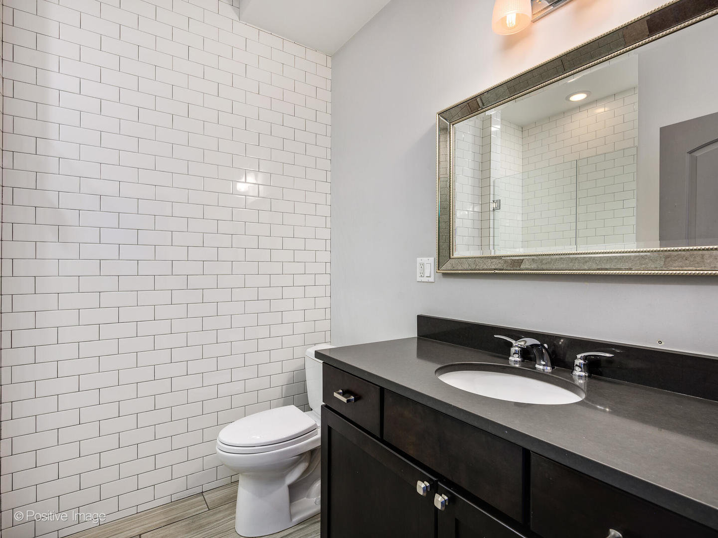 33 North Morgan Street, Unit PH Chicago, IL 60607 - Photo 15 of 24 a bathroom with a sink a toilet and a mirror