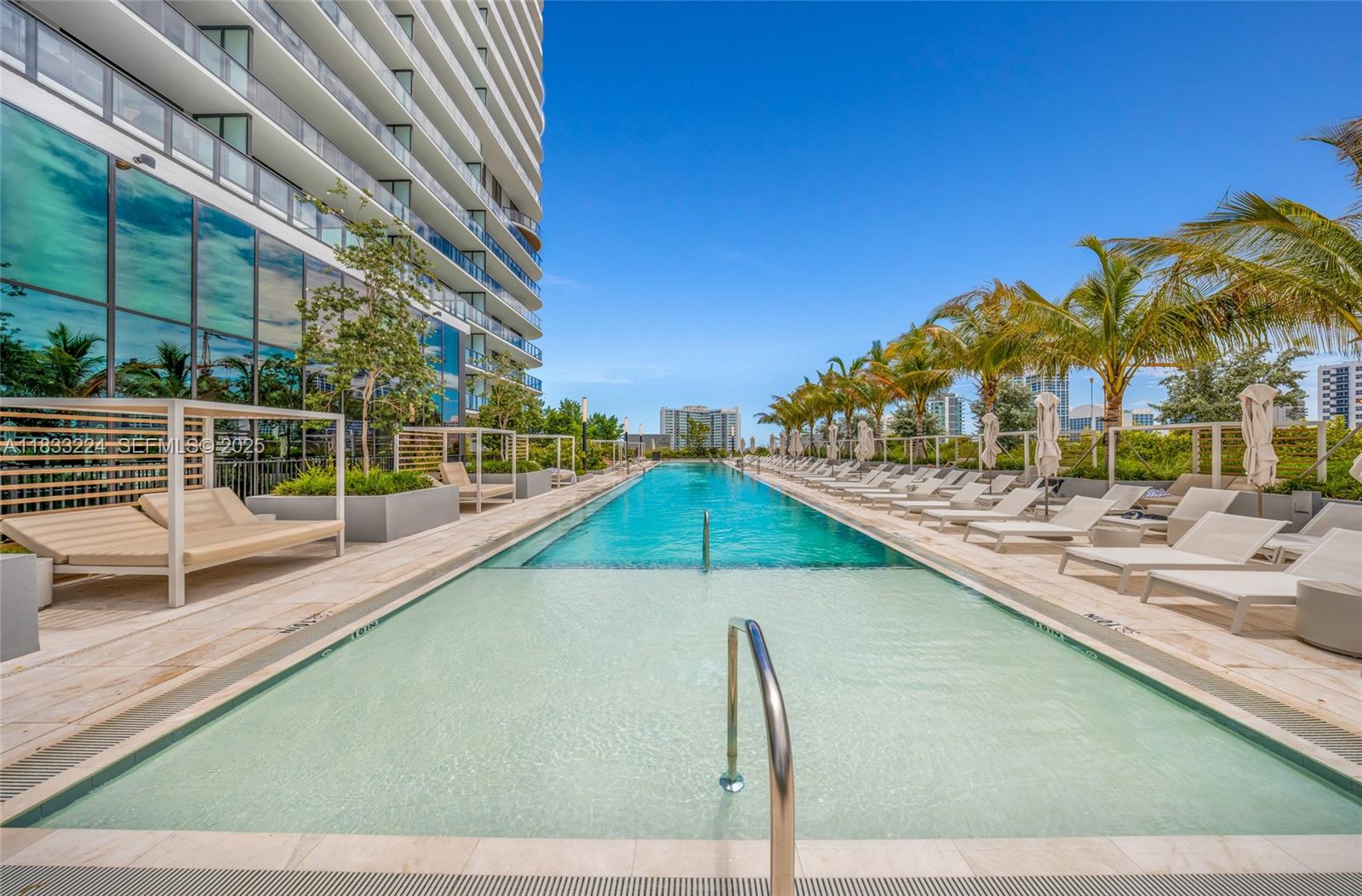 580 72nd Street, Unit 910 Miami Beach, FL 33141 - Photo 21 of 60 a view of a swimming pool with a terrace
