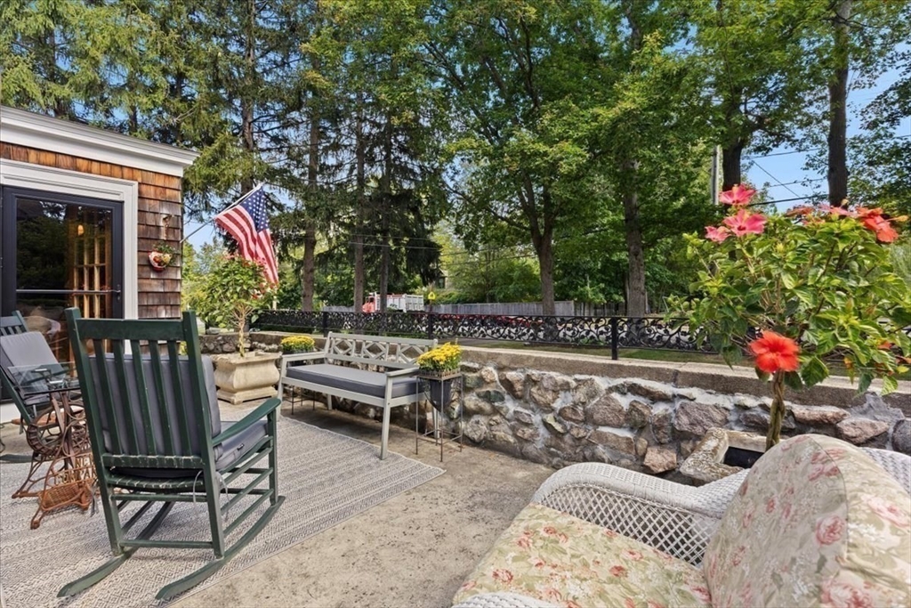 155 Mt Vernon Street Dedham, MA 02026 - Photo 17 of 50 a roof deck with table and chairs and potted plants