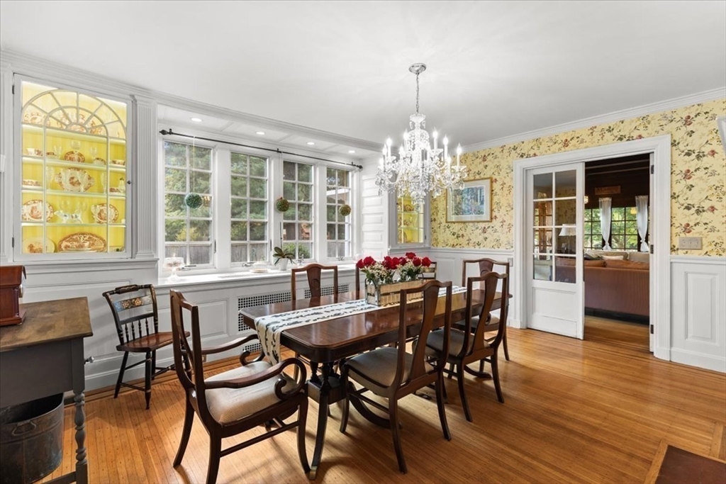 155 Mt Vernon Street Dedham, MA 02026 - Photo 22 of 50 a view of a dining room with furniture a chandelier and wooden floor