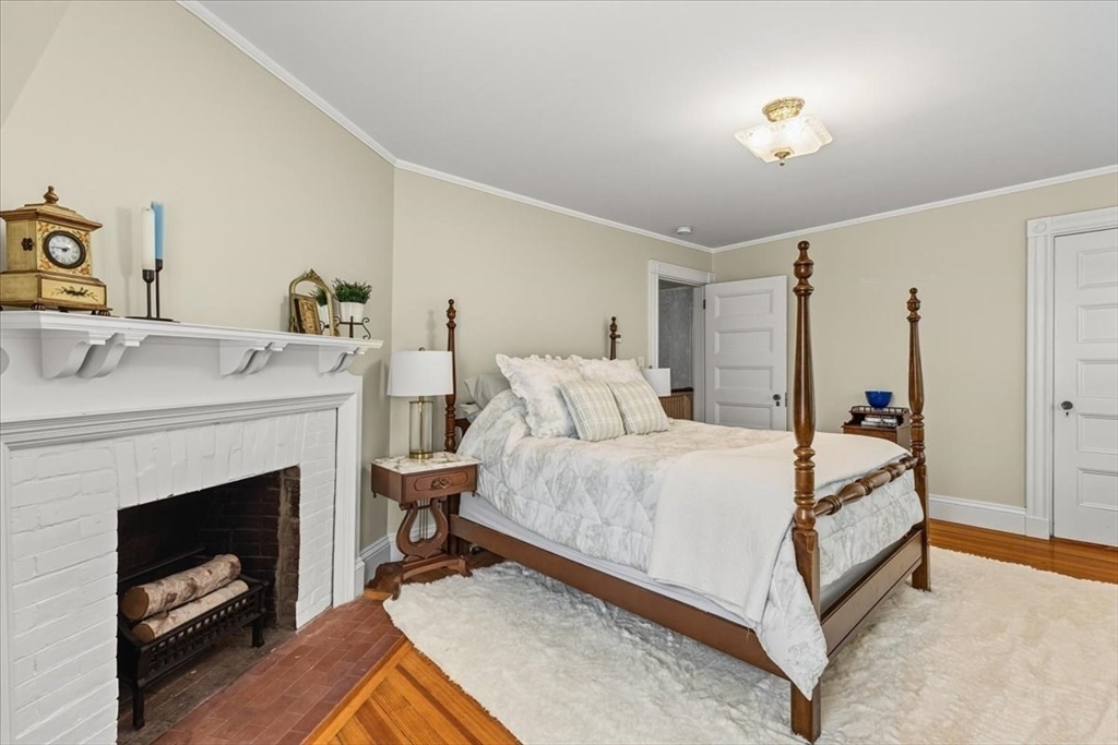 155 Mt Vernon Street Dedham, MA 02026 - Photo 34 of 50 a bed room with a bed and a fireplace